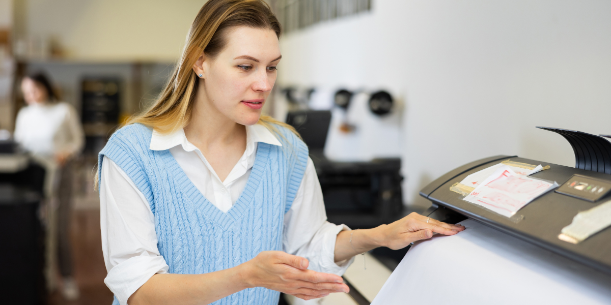 Woman using wide-format printer