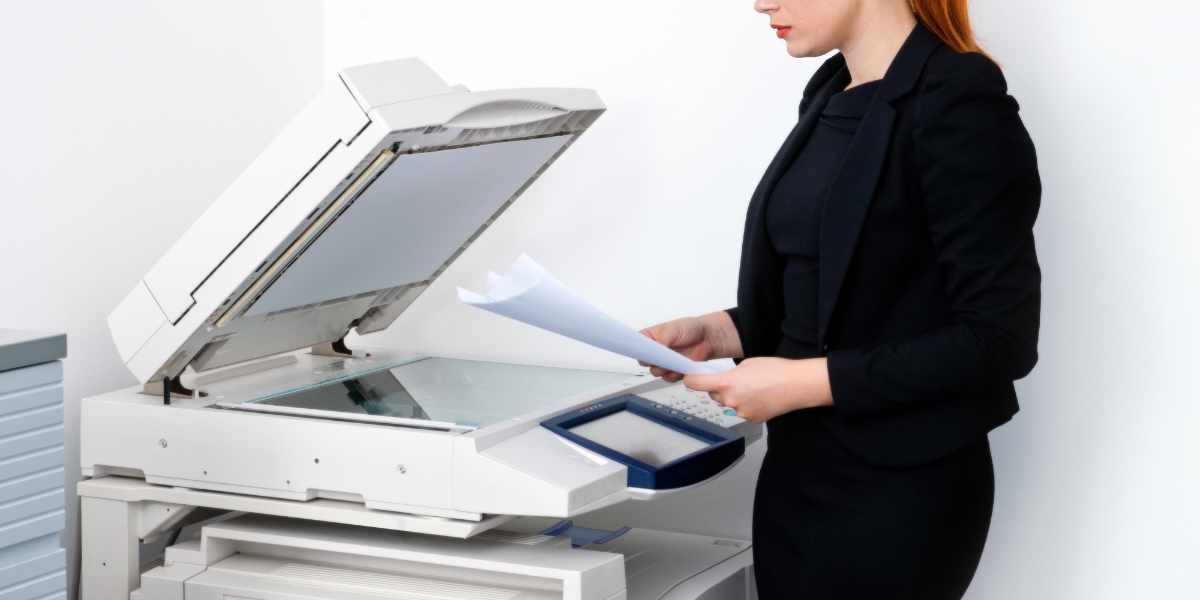woman using printer with ease thanks to printing software solutions.