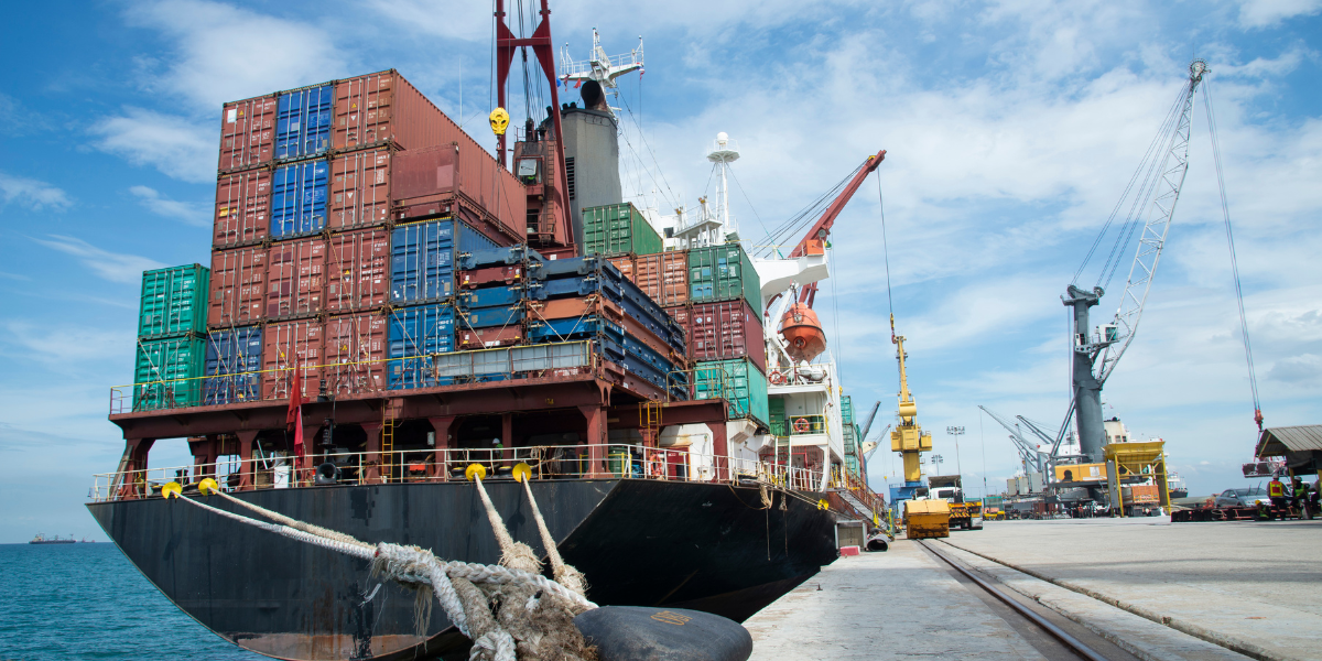 Shipping containers on back of docked ship