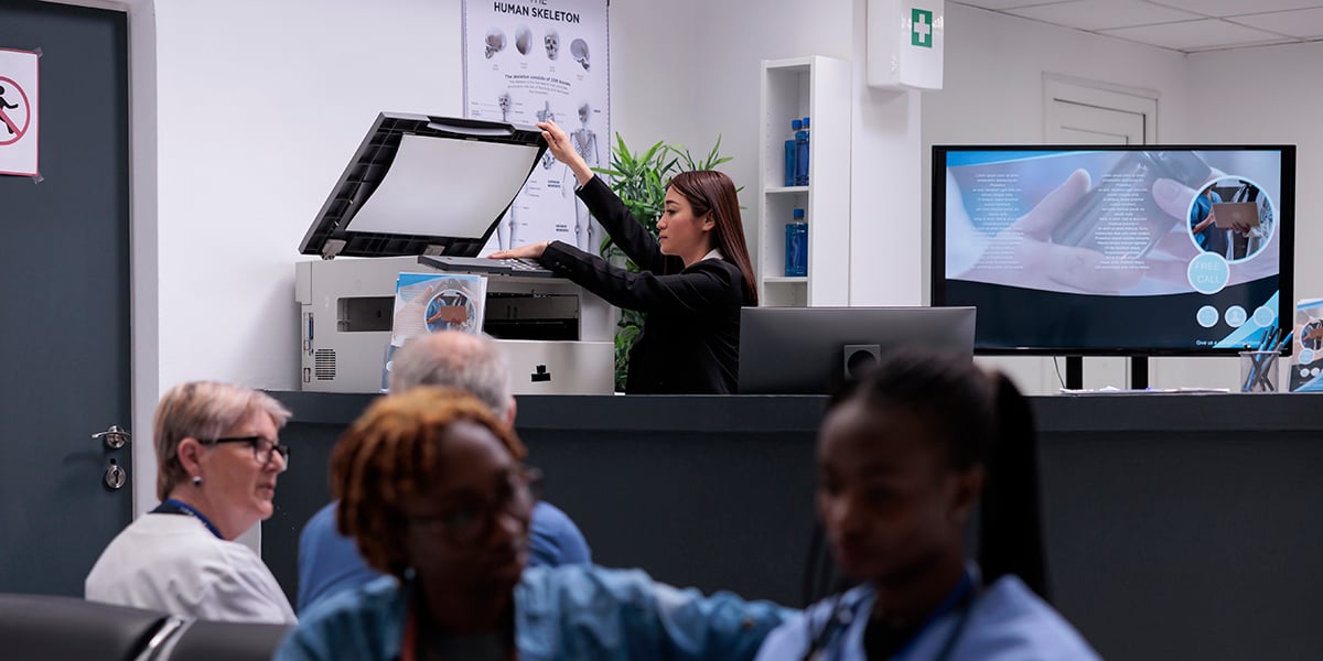 Female secretary working with copy printer