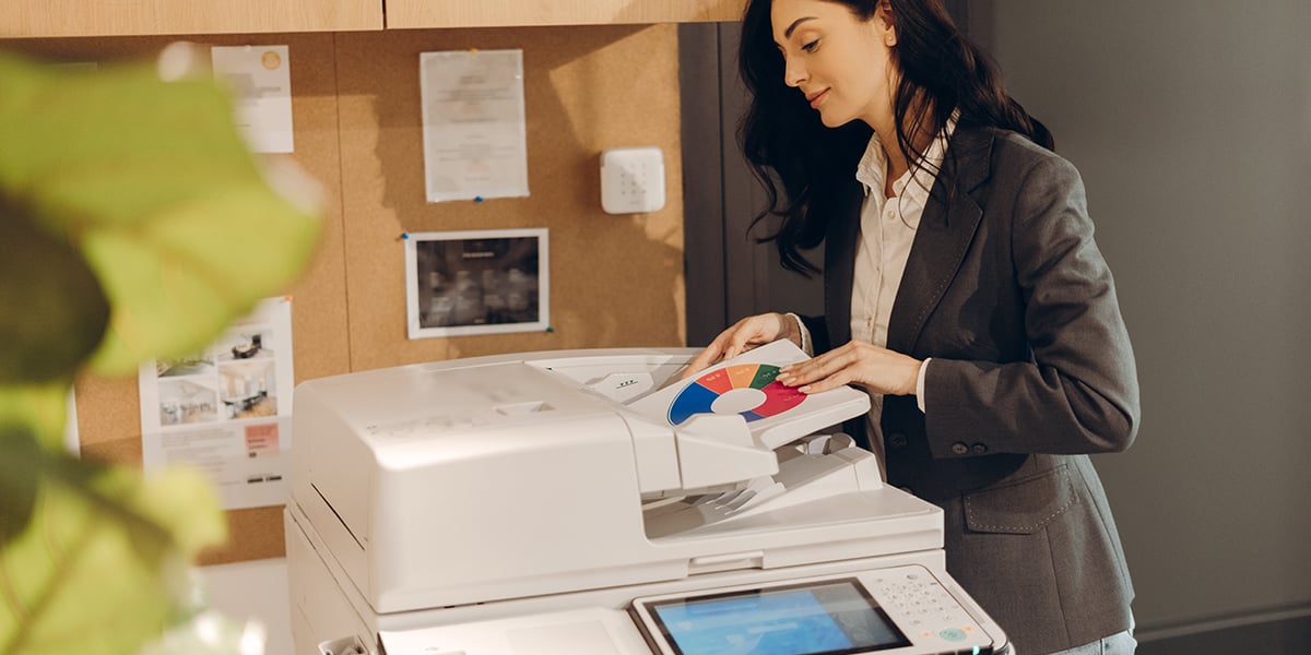 Professional Woman Using Office Printer at Work